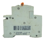 Side profile of Schneider 32A 4P miniature circuit breaker showing barcode and DIN rail clip