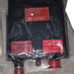 Honeywell 3888058-7 Ignition Exciter unit with terminal layout and warning label
