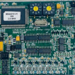 Close-up of Rolls Royce RRAIO16F PCB microprocessor, rotary dials, and IC chips
