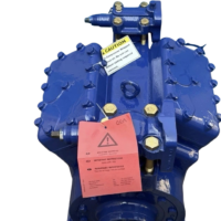Top-front angle of blue GEA Bock FX14-1366 4-cylinder marine open compressor with caution tag